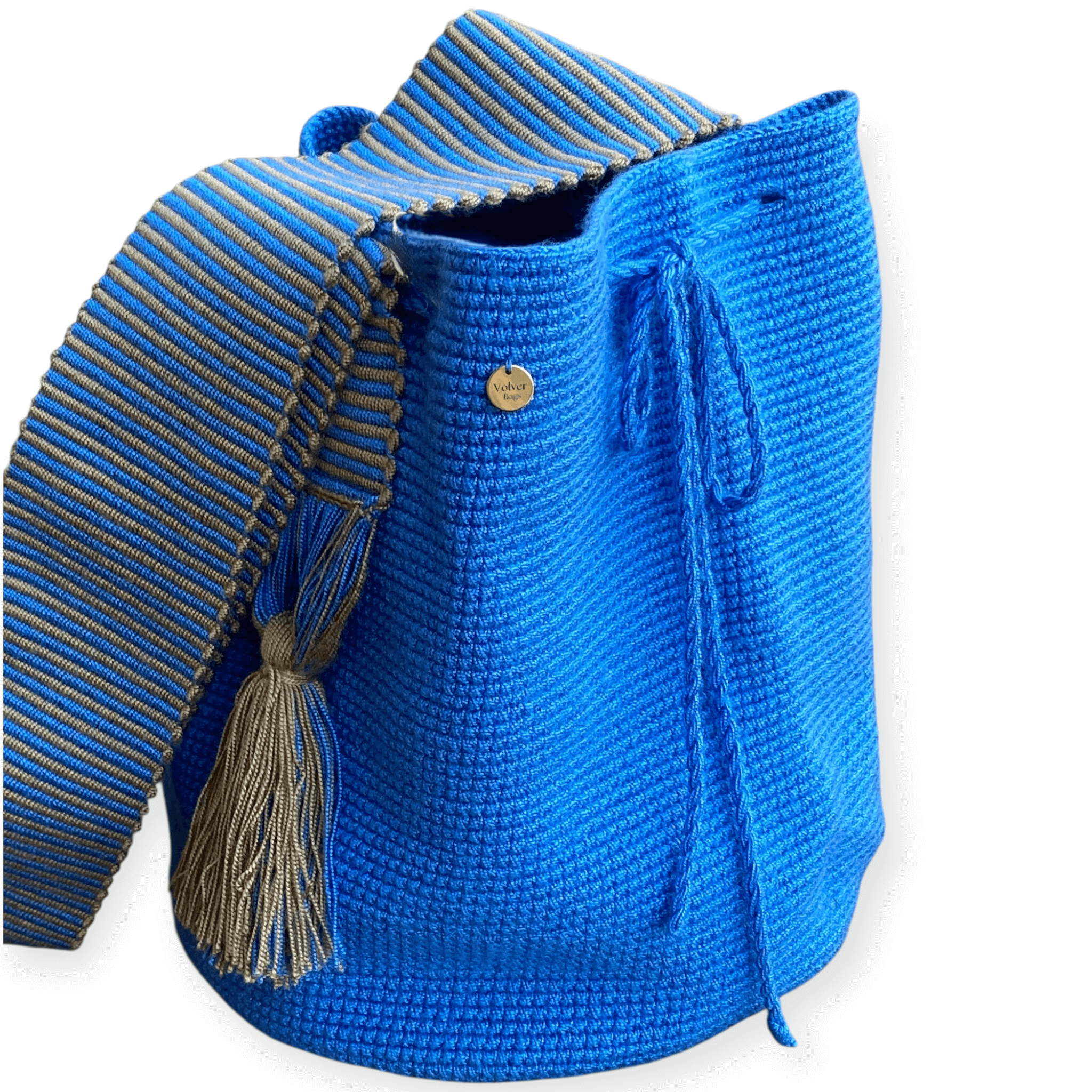 Prospettiva laterale con focus sulla medaglietta Volver Bags e sulla lavorazione della tracolla della borsa in cotone intrecciata a mano dalle donne Wayuu in Colombia –